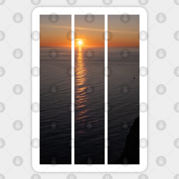 Wonderful landscapes in Norway. Nord-Norge. Beautiful scenery of a midnight sun sunset at Nordkapp (Cape North). Boat and globe on a cliff. Rippled sea and clear orange sky. (vertical) Sticker by fabbroni-art